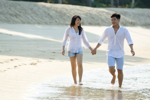 happy couple by the sea on the beach