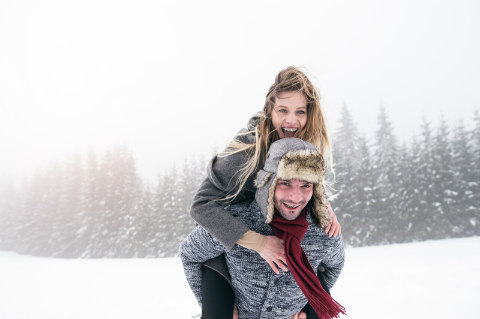 Couple playing in the snow.