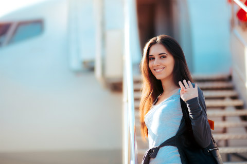 girlfriend waving leaving on airplane at airport