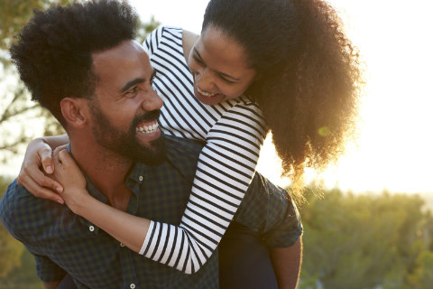 happy smiling African-American couple hugging
