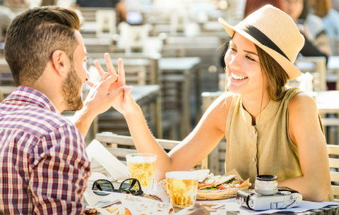 couple having drinks holding hands