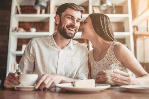 Boyfriend and girlfriend sharing a secret